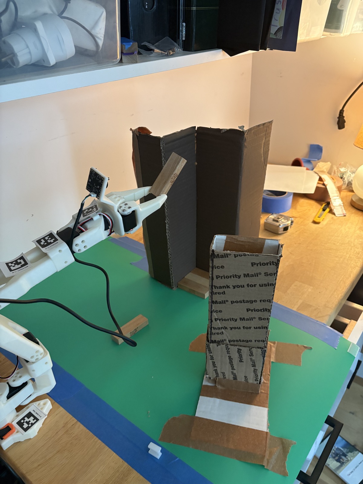 Mid-pull: the follower arm drawing a block out of the dispenser.